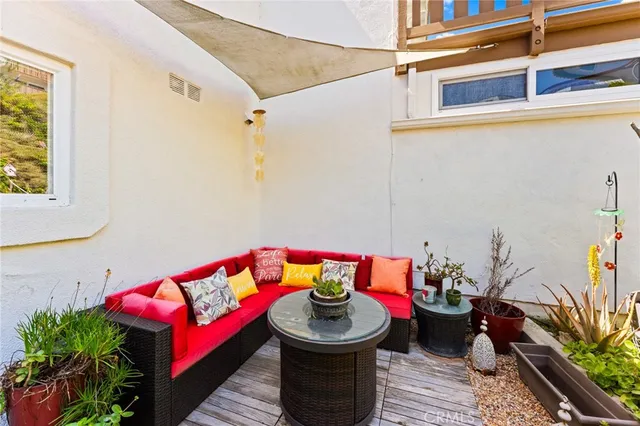 a living room with furniture and a potted plant
