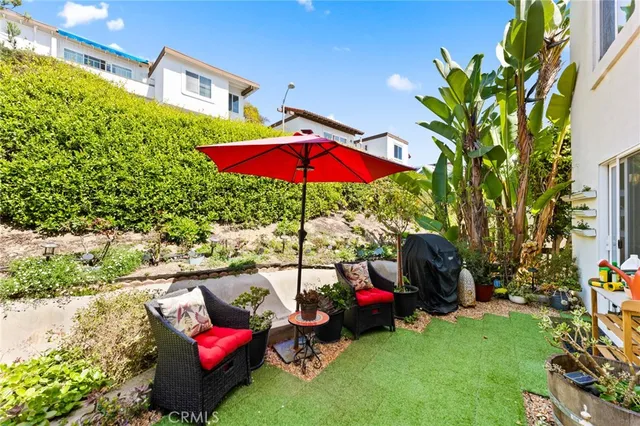 a view of a backyard with sitting area and furniture