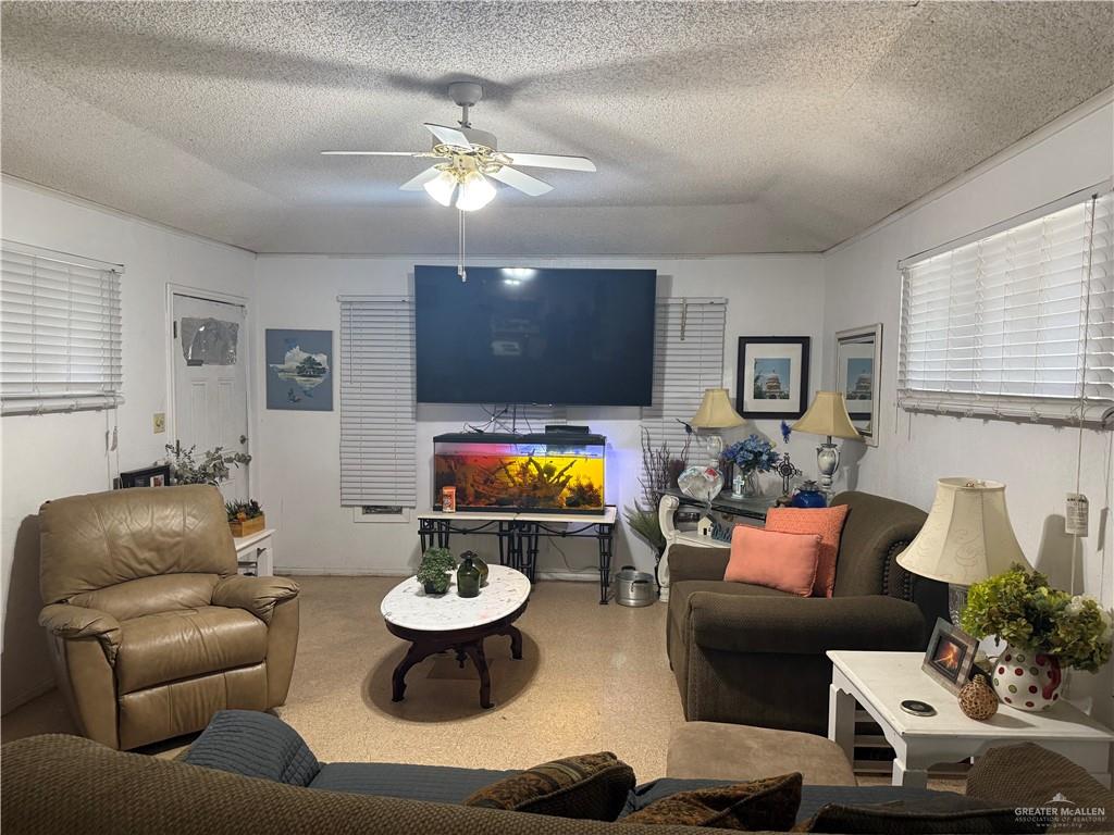 815 South Breyfogle Road Mission, TX 78572 - Photo 3 of 5 Living area with ceiling fan and a textured ceiling