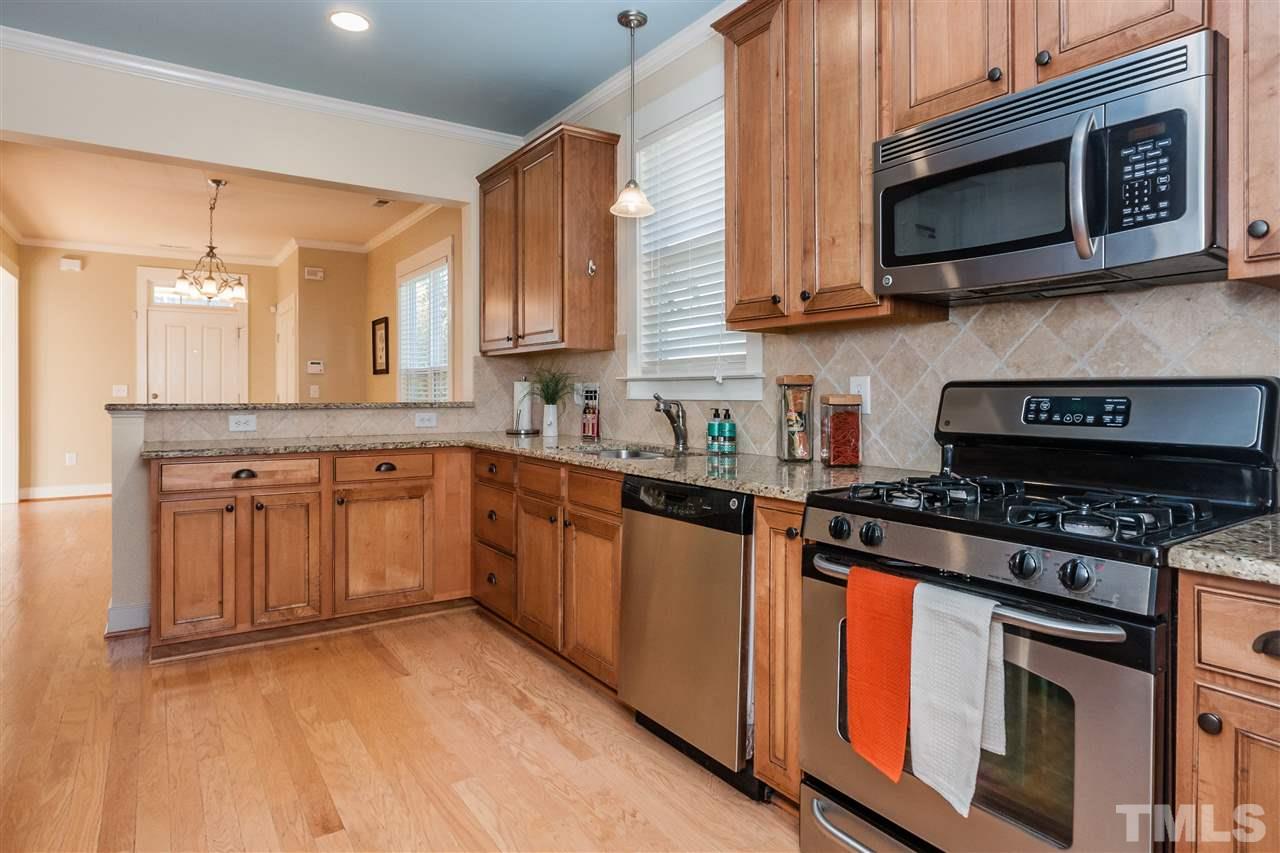 2224 Dunlin Lane Raleigh, NC 27614 - Photo 11 of 23 a kitchen with stainless steel appliances granite countertop a stove a sink and a microwave