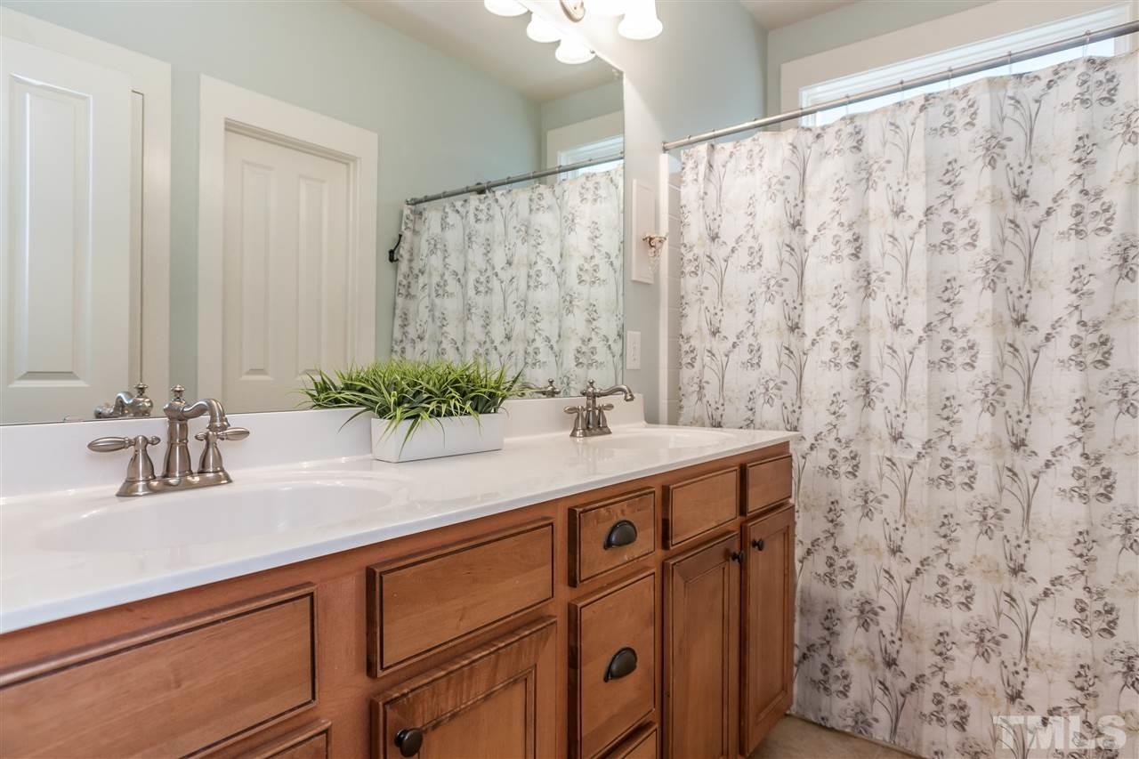 2224 Dunlin Lane Raleigh, NC 27614 - Photo 15 of 23 a bathroom with a granite countertop sink and a mirror