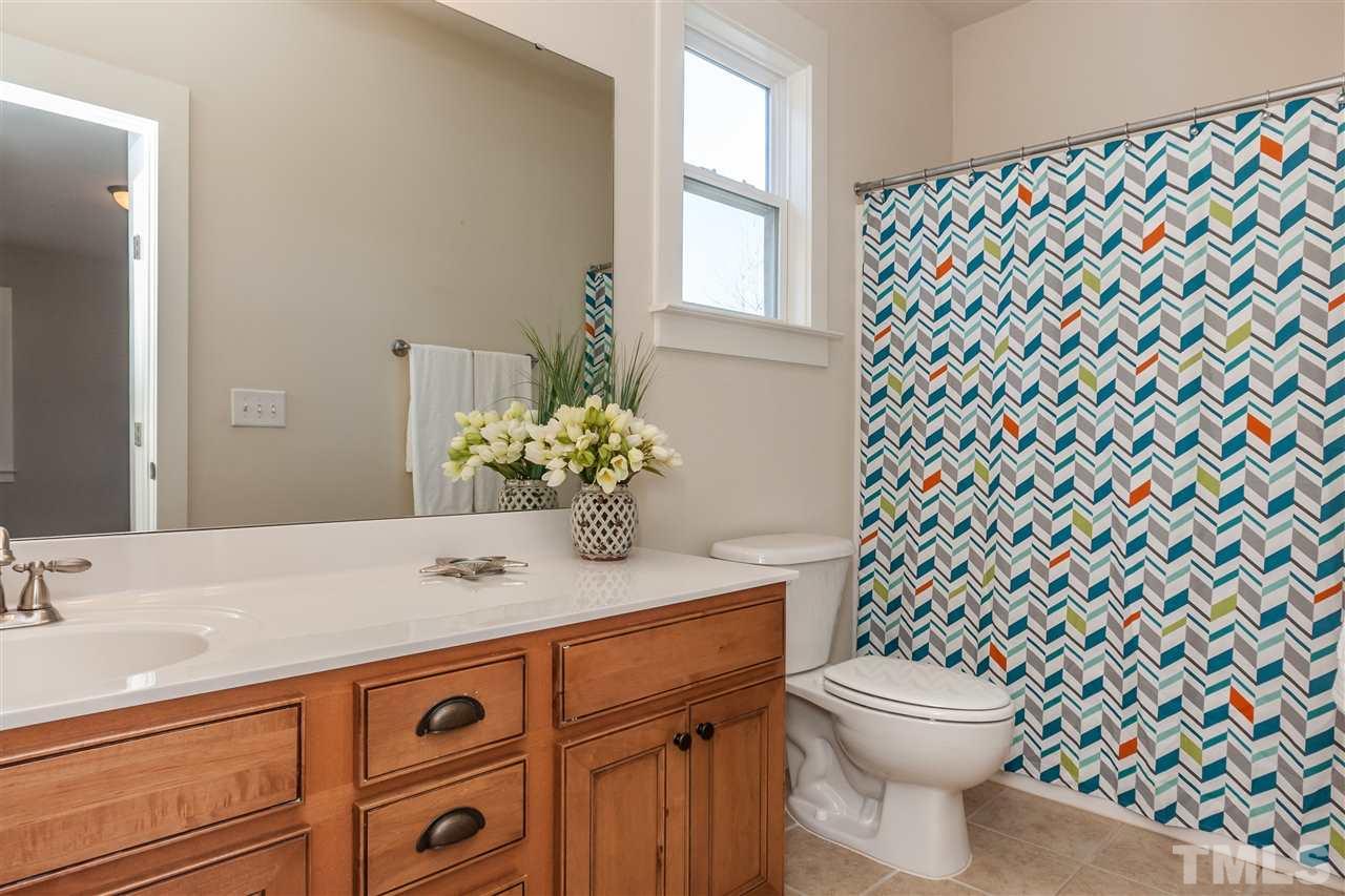 2224 Dunlin Lane Raleigh, NC 27614 - Photo 19 of 23 a bathroom with a sink a toilet and a mirror