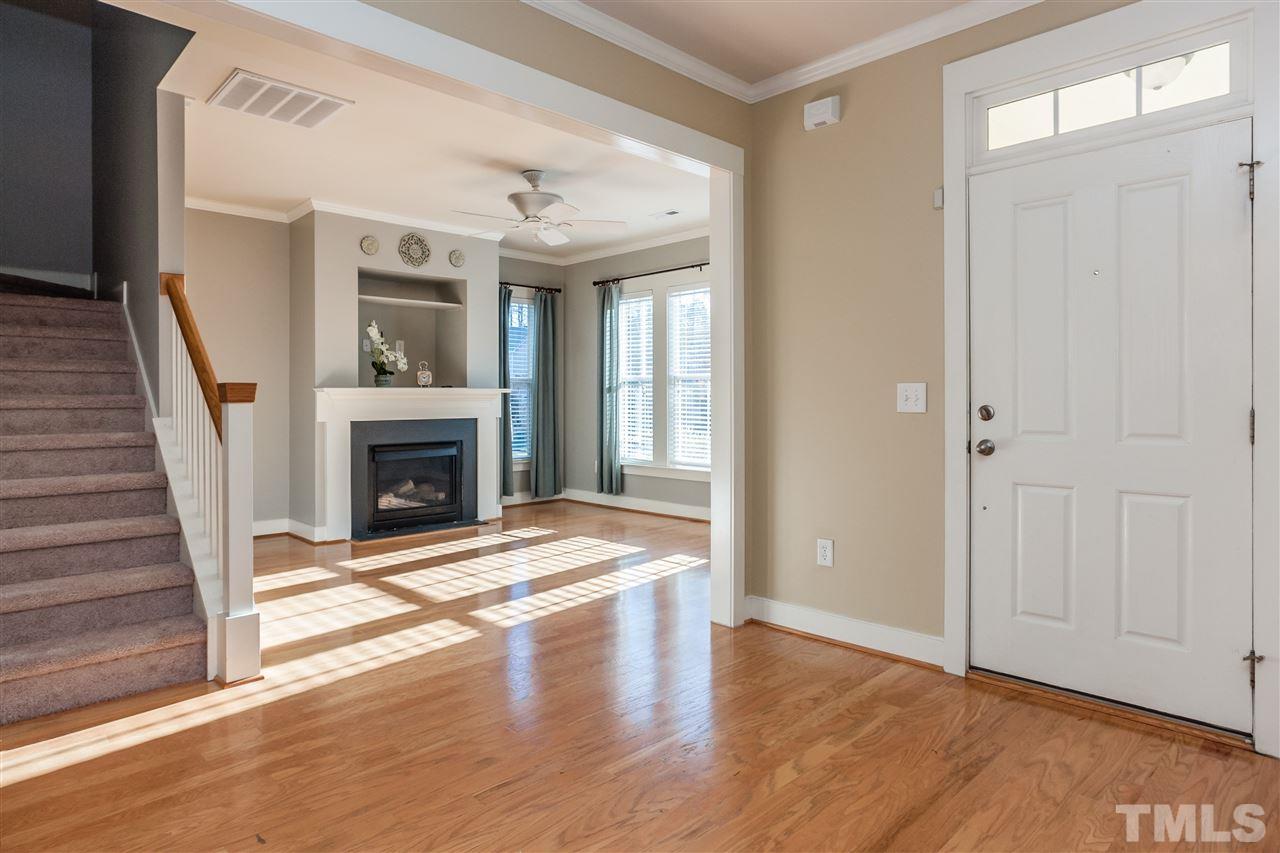 2224 Dunlin Lane Raleigh, NC 27614 - Photo 3 of 23 a view of an empty room with wooden floor fireplace and a window