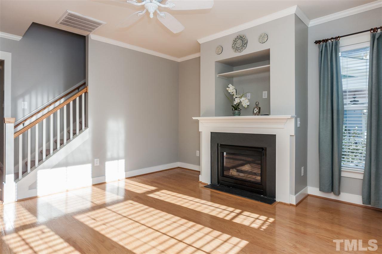 2224 Dunlin Lane Raleigh, NC 27614 - Photo 7 of 23 a living room with a fireplace and a rug