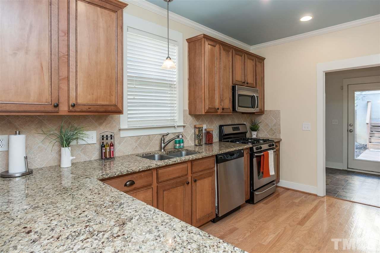 2224 Dunlin Lane Raleigh, NC 27614 - Photo 9 of 23 a kitchen with stainless steel appliances granite countertop a stove a sink and a microwave