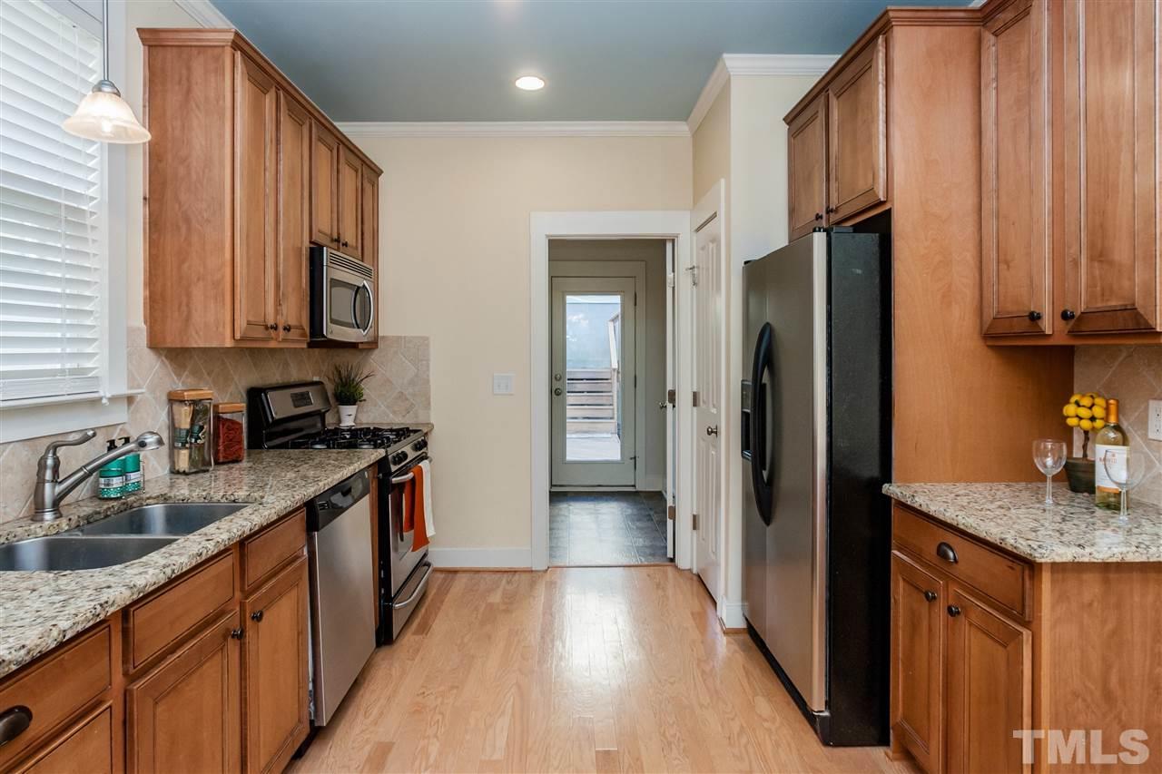 2224 Dunlin Lane Raleigh, NC 27614 - Photo 10 of 23 a kitchen with stainless steel appliances granite countertop a refrigerator a sink dishwasher and wooden cabinets with wooden floor