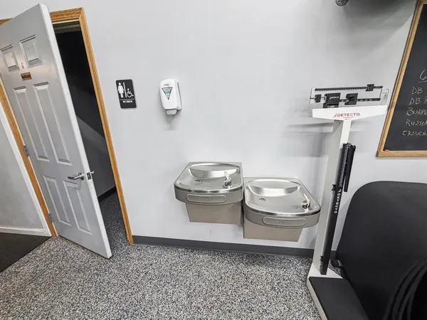 a white toilet sitting next to a bathroom sink