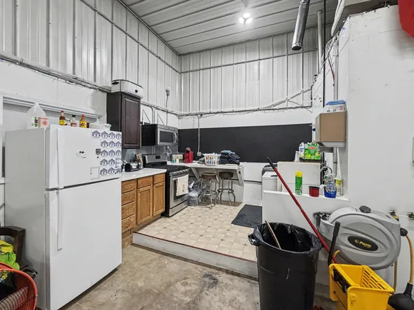 a kitchen with a refrigerator a stove and a wooden floors
