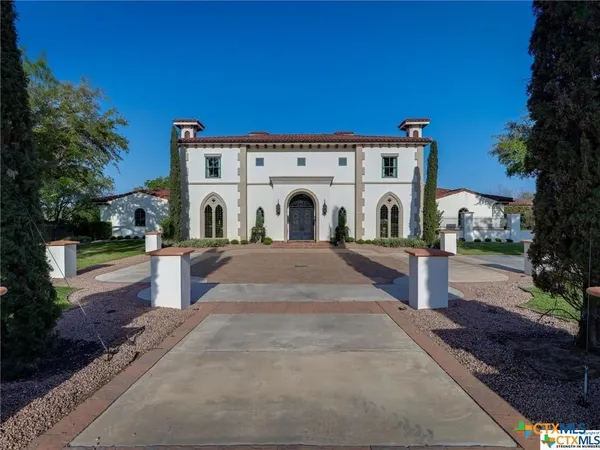 a view of a white house with a yard