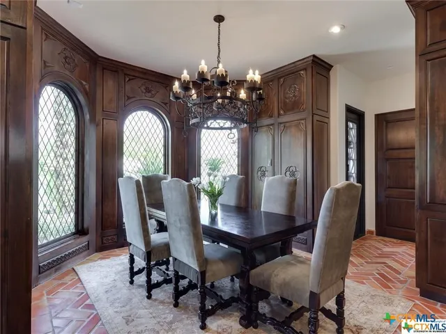 a bedroom with a bed potted plant on the dresser and a window
