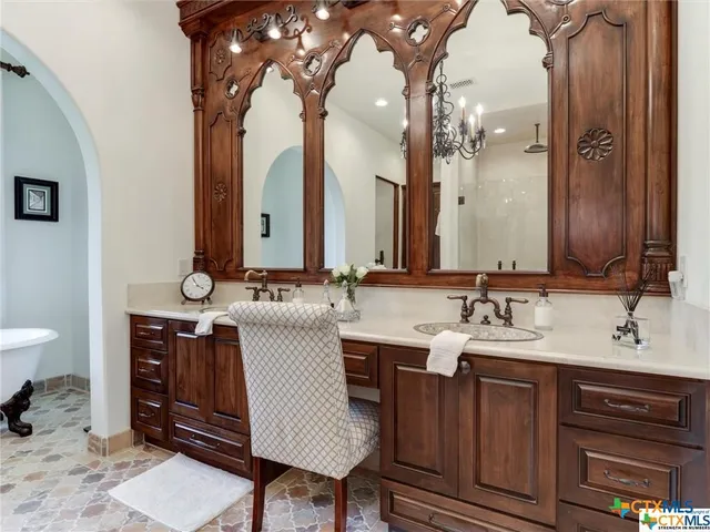 a patio with a table and chairs under an umbrella