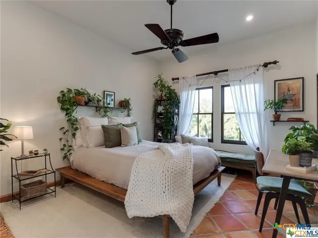 a living room with furniture a rug and a large window