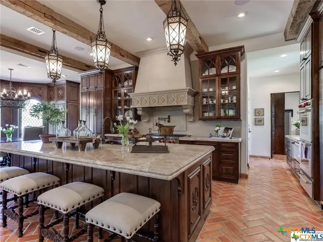 a view of a kitchen counter top space a sink stainless steel appliances and cabinets