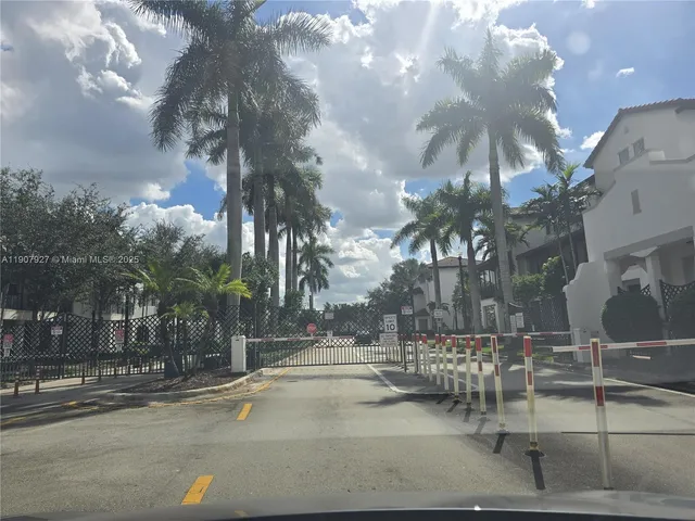 a view of a park with iron fence