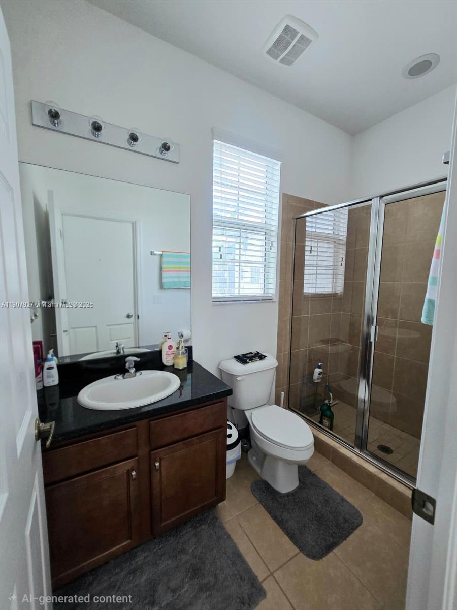 11938 Southwest 26th Court Miramar, FL 33025 - Photo 20 of 61 a bathroom with a granite countertop sink toilet mirror and a shower