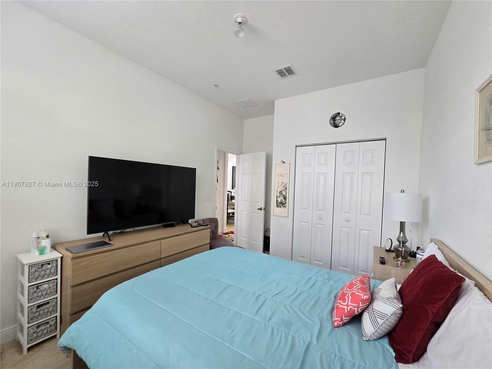 11938 Southwest 26th Court Miramar, FL 33025 - Photo 25 of 61 a bedroom with a bed and a flat screen tv