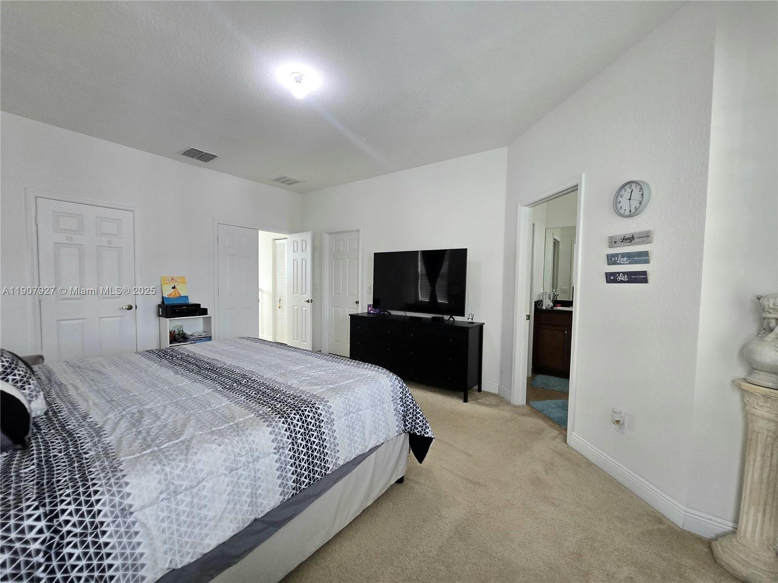 11938 Southwest 26th Court Miramar, FL 33025 - Photo 35 of 61 a bedroom with a bed and a tv