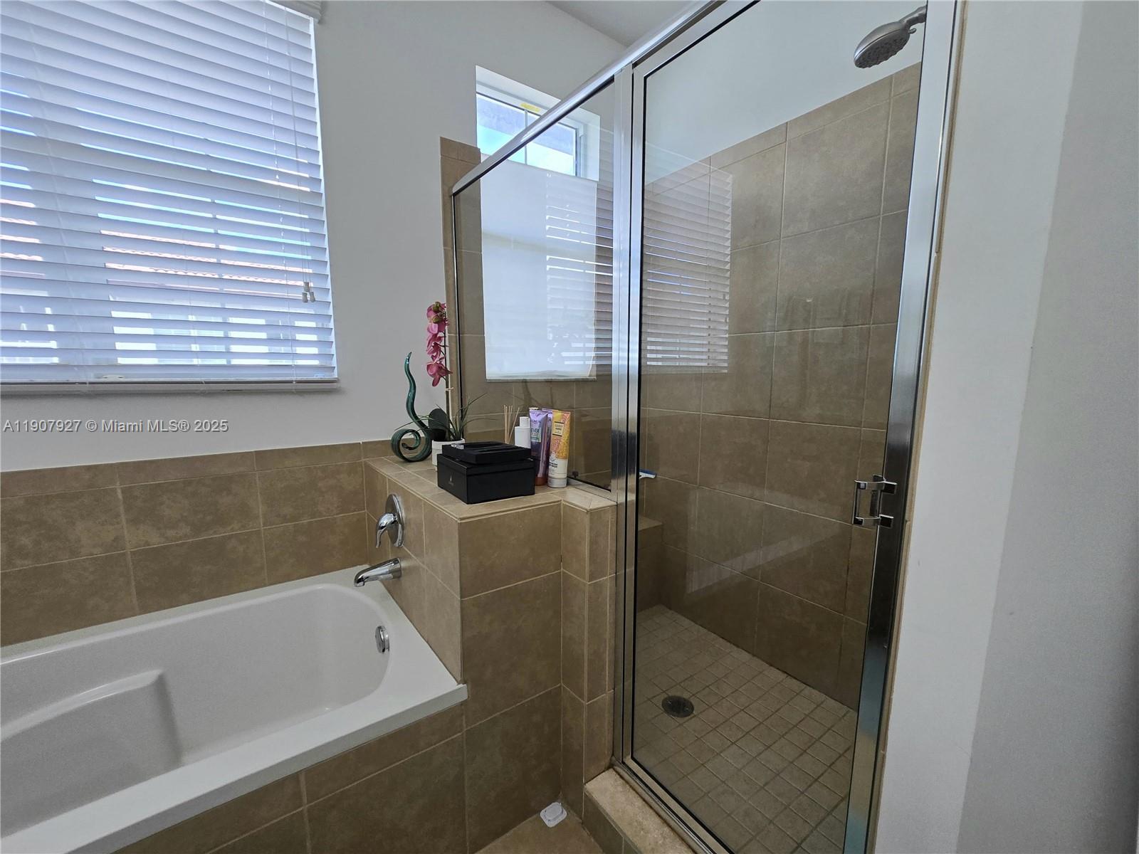 11938 Southwest 26th Court Miramar, FL 33025 - Photo 39 of 61 a bathroom with a bathtub and a shower