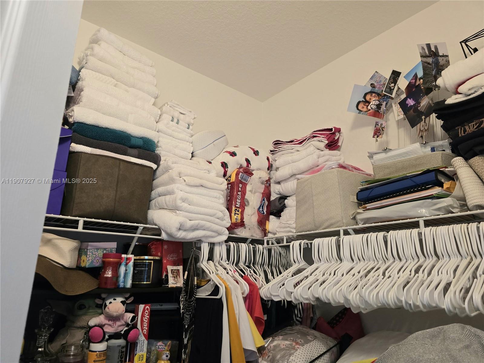 11938 Southwest 26th Court Miramar, FL 33025 - Photo 41 of 61 a view of walk in closet with clothes and shoes