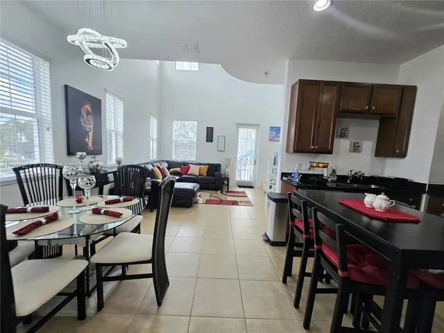 a view of a dining room with furniture and a chandelier