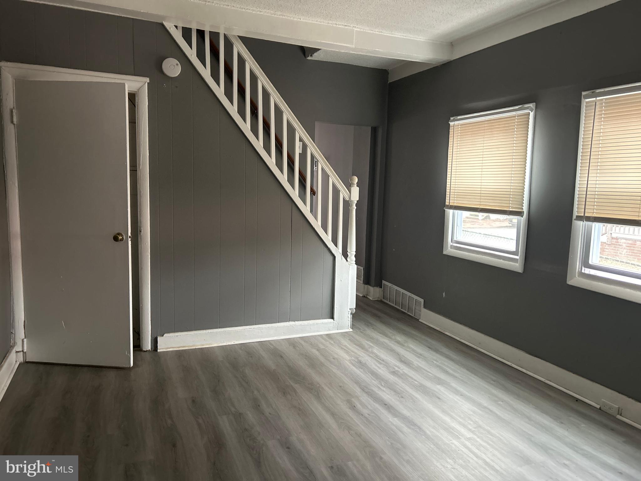 24 West Monroe Street Mount Holly, NJ 08060 - Photo 1 of 20 a view of an empty room with wooden floor and stairs