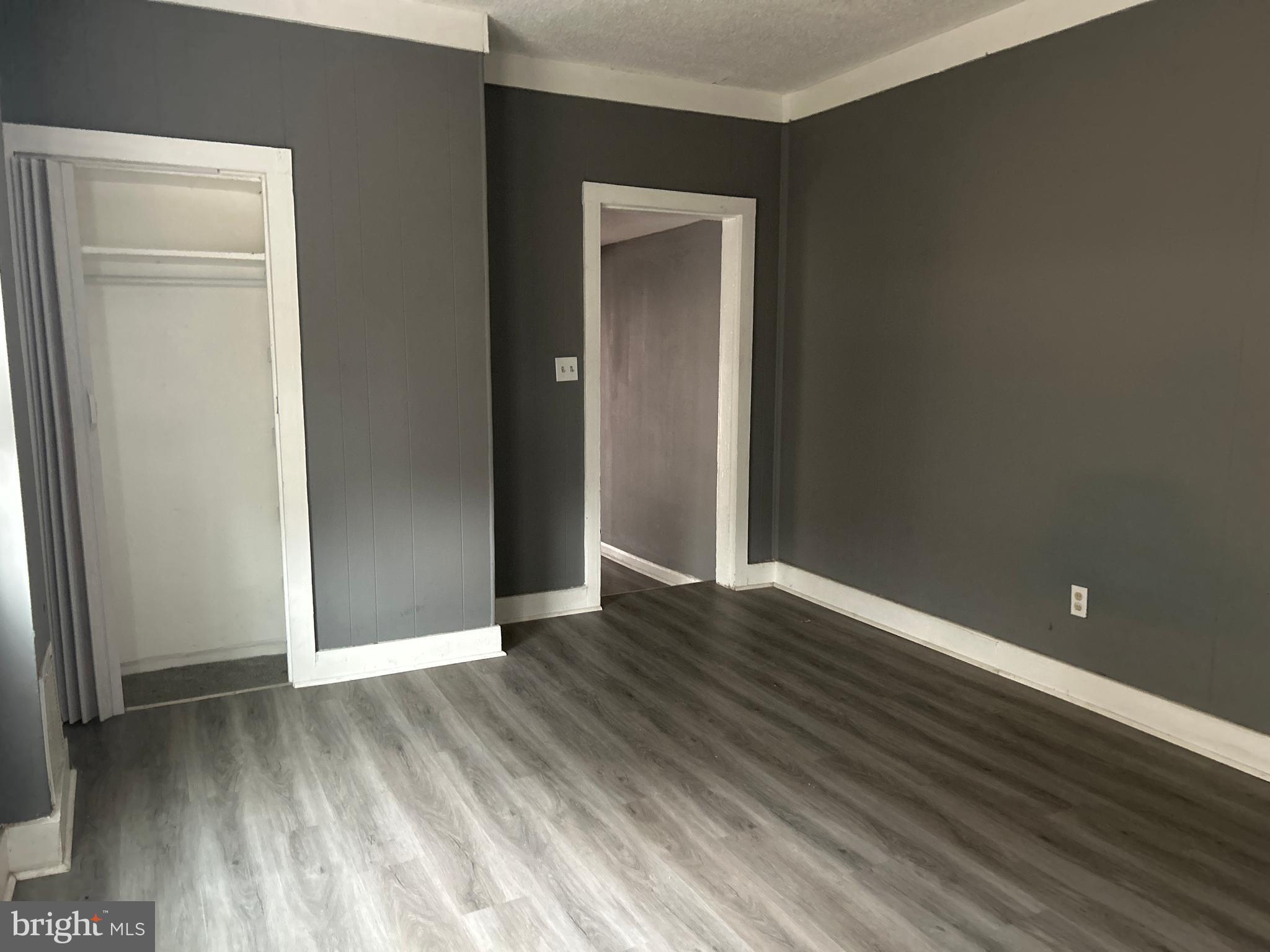 24 West Monroe Street Mount Holly, NJ 08060 - Photo 14 of 20 a view of an empty room with wooden floor and a window