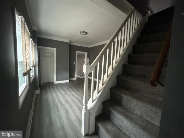 a view of staircase with lots of frames and wooden floor