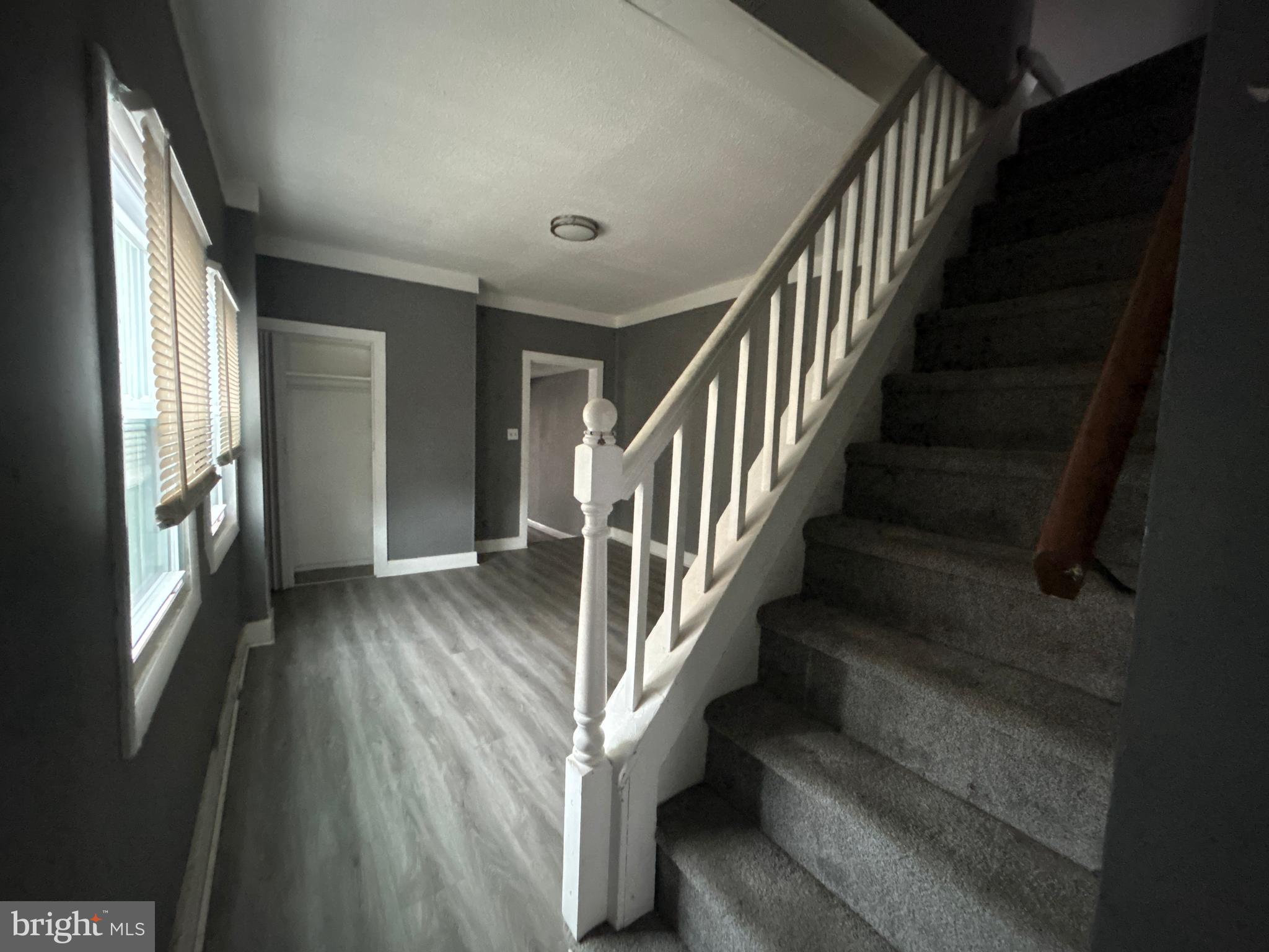 24 West Monroe Street Mount Holly, NJ 08060 - Photo 3 of 20 a view of staircase with lots of frames and wooden floor
