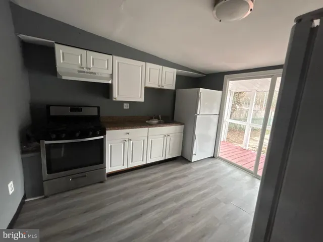 a kitchen with a sink a microwave and cabinets