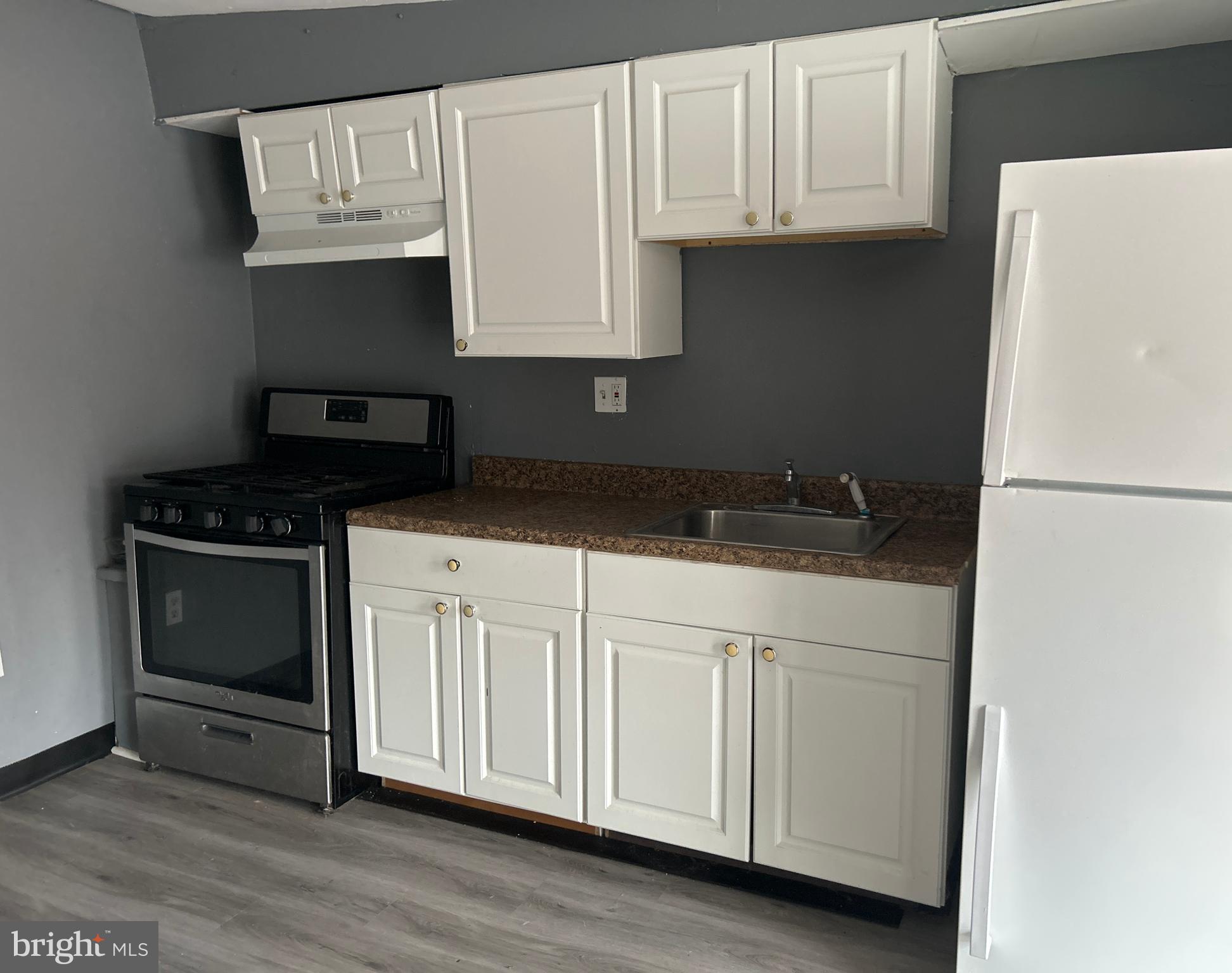 24 West Monroe Street Mount Holly, NJ 08060 - Photo 7 of 20 a kitchen with granite countertop white cabinets and black appliances