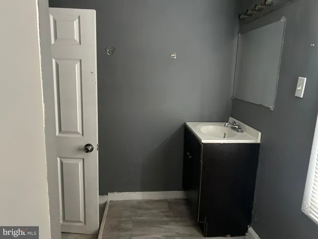 a bathroom with a sink and mirror