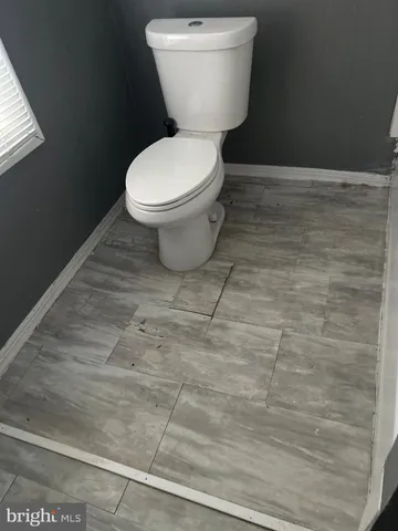 a white toilet sitting next to a sink