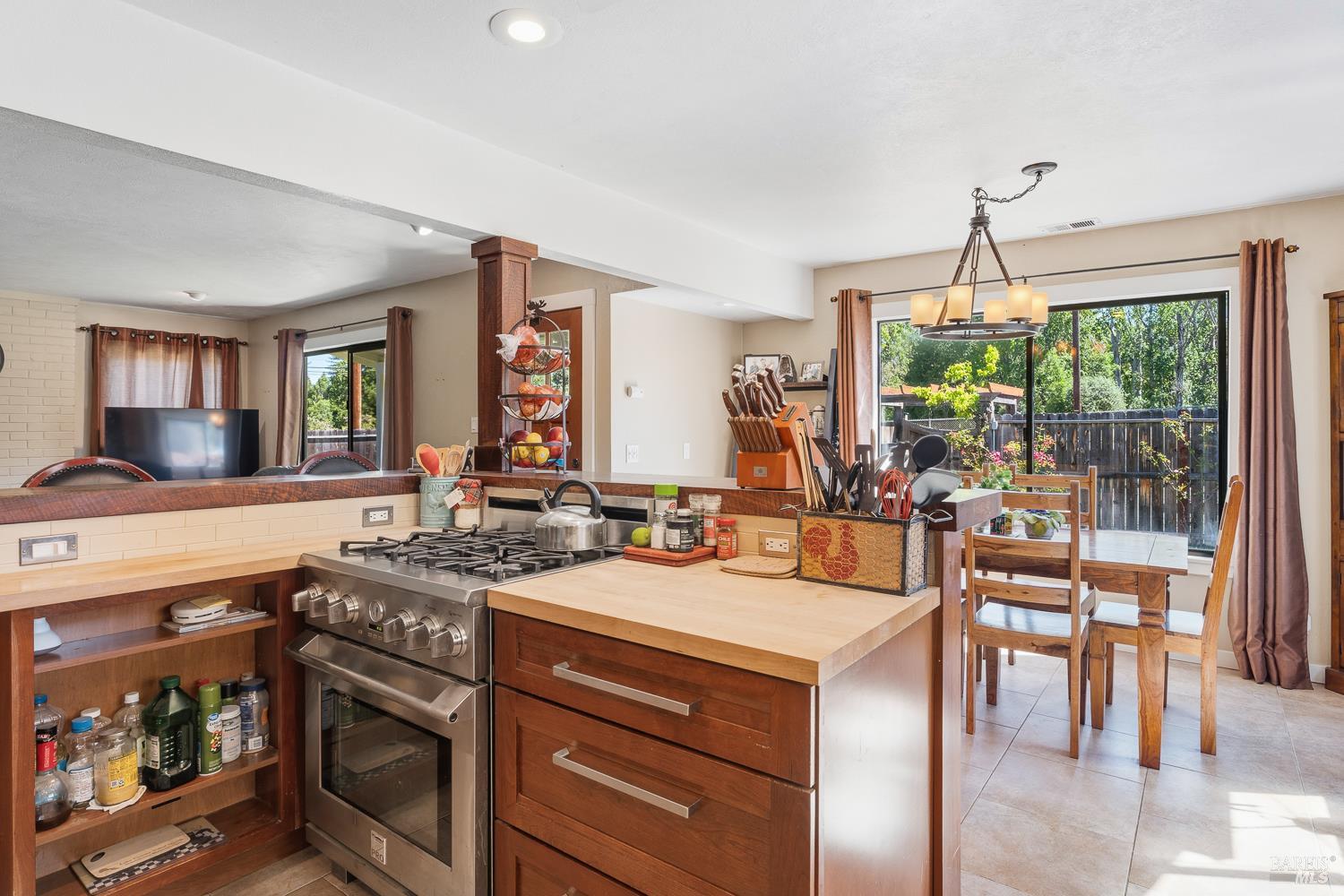 2260 Old River Road Ukiah, CA 95482 - Photo 17 of 29 a kitchen with a stove a sink and a dining table