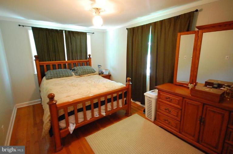 2141 Firethorn Road Middle River, MD 21220 - Photo 12 of 16 a bedroom with a bed window and dresser