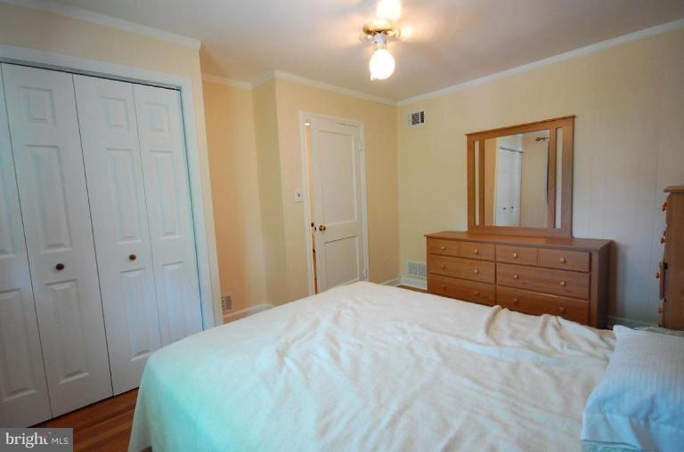 2141 Firethorn Road Middle River, MD 21220 - Photo 3 of 16 a bedroom with a bed and a dresser