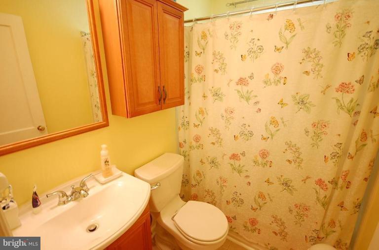 2141 Firethorn Road Middle River, MD 21220 - Photo 8 of 16 a white toilet sitting next to a shower curtain