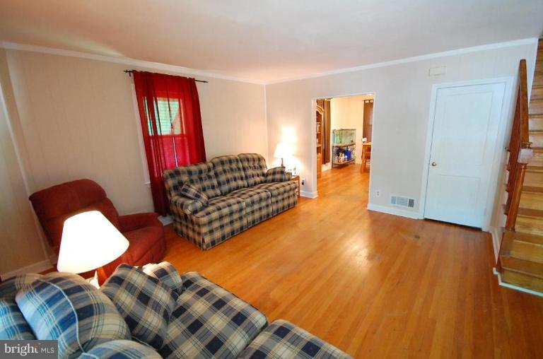 2141 Firethorn Road Middle River, MD 21220 - Photo 10 of 16 a living room with furniture rug and wooden floor