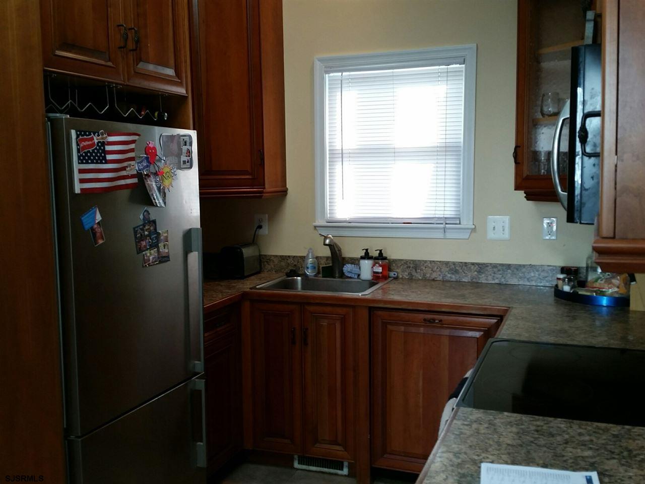 9 Wesley Road Ocean City, NJ 08226 - Photo 12 of 25 a kitchen with stainless steel appliances granite countertop a refrigerator and a sink