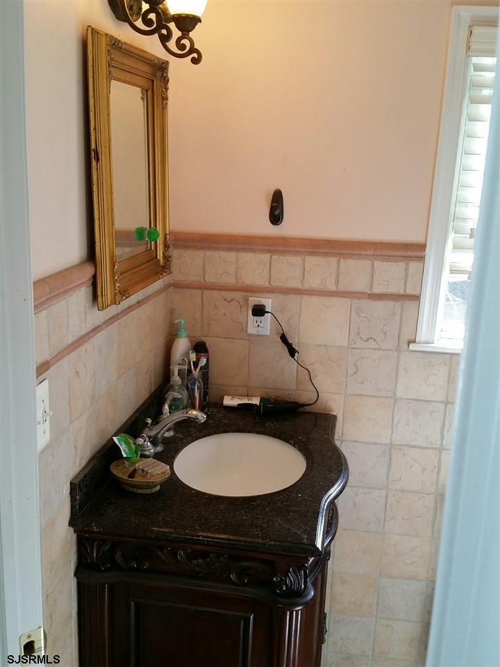 9 Wesley Road Ocean City, NJ 08226 - Photo 16 of 25 a bathroom with a sink a toilet and mirror