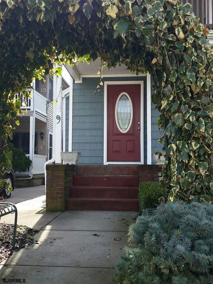 9 Wesley Road Ocean City, NJ 08226 - Photo 3 of 25 a wooden bench sitting in front of a building