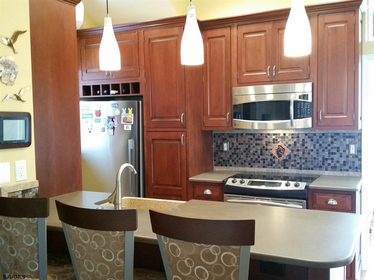 9 Wesley Road Ocean City, NJ 08226 - Photo 25 of 25 a kitchen with a table chairs and a stove