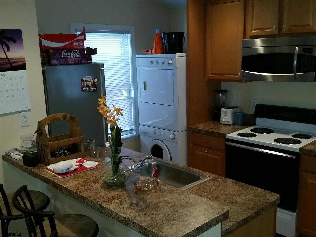9 Wesley Road Ocean City, NJ 08226 - Photo 5 of 25 a kitchen with a stove and a sink