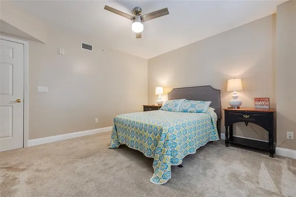 a bedroom with a bed and a ceiling fan