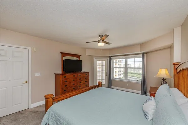 a bedroom with a bed and a television