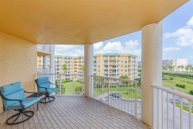 a view of a balcony with chair and table