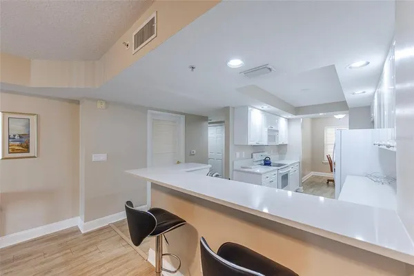 a view of a kitchen counter space and wooden floor