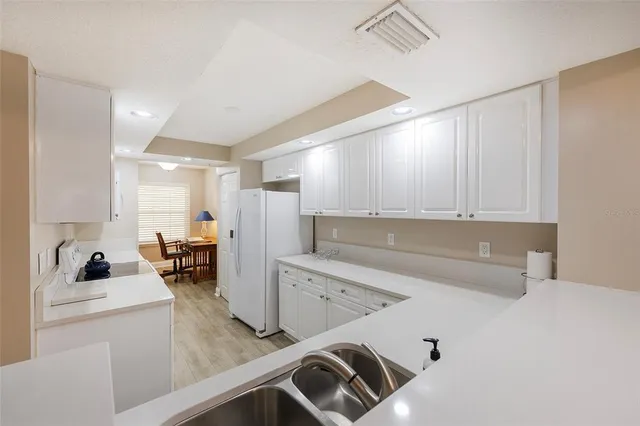 a kitchen with a sink appliances and cabinets