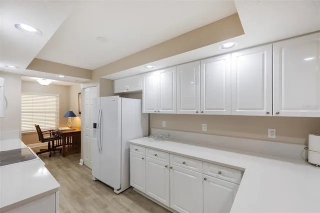 a kitchen with stainless steel appliances granite countertop a refrigerator sink and cabinets