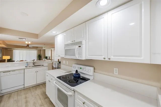 a kitchen with a sink stove top oven and cabinets