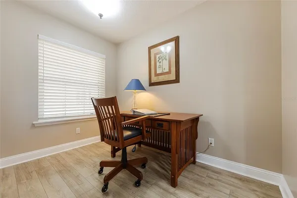 a view of a workspace with furniture and a window